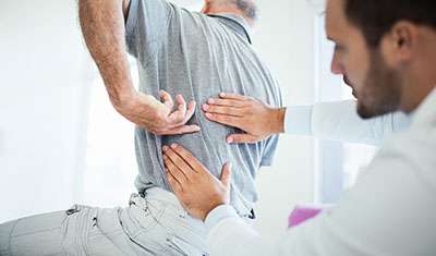 chiropractor evaluating a patient